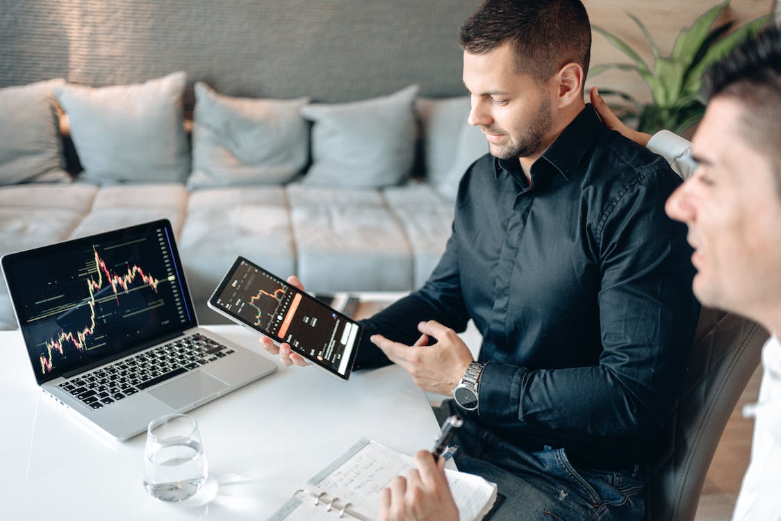 man with laptop and tab learning trading
